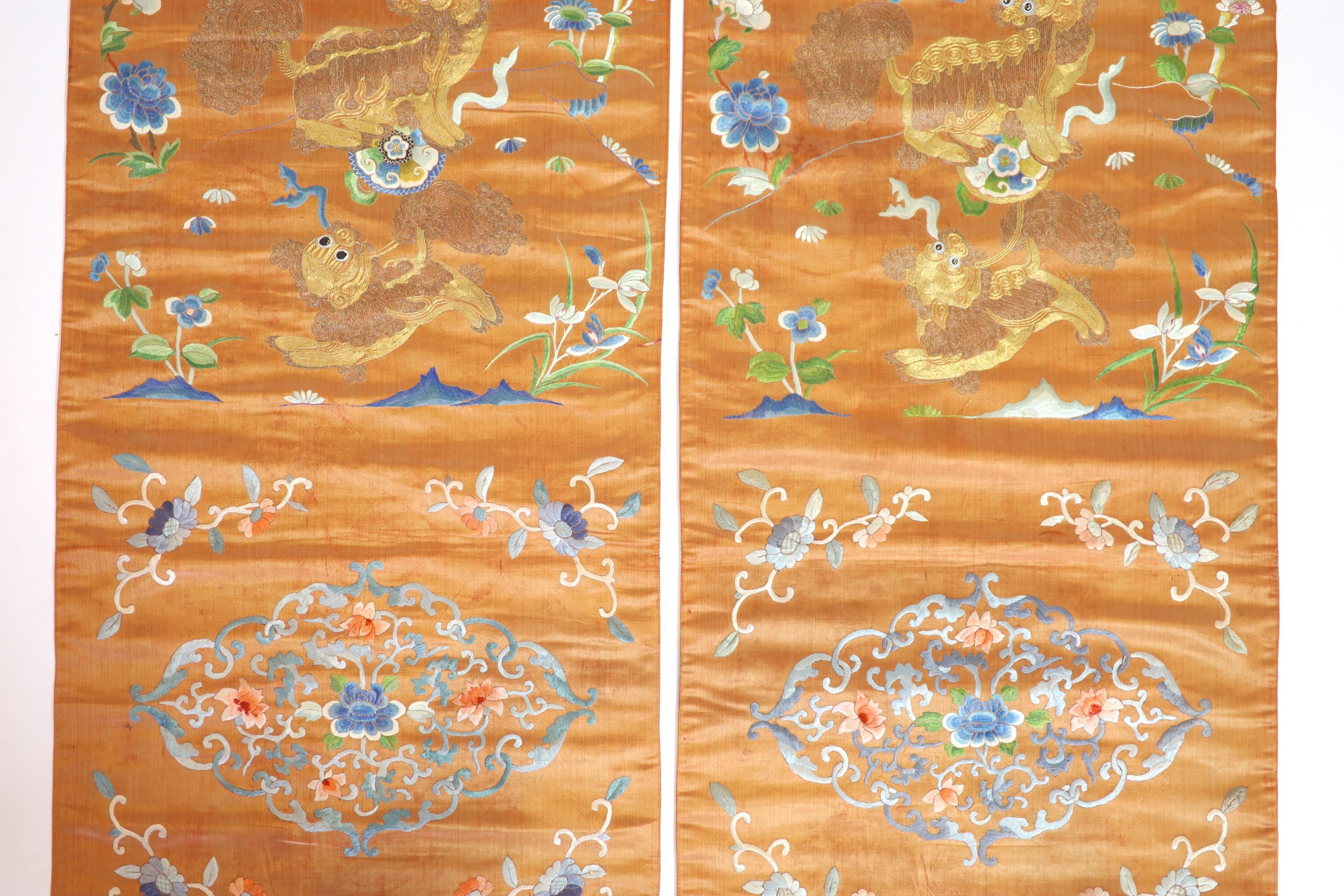 A pair of Chinese peach silk embroidered hangings, 19th century 137 x 44 cm
